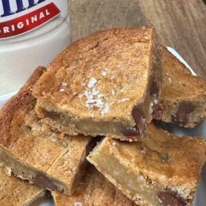 Malted Milk Powder Blondies with sea salt sprinkled on top and milk chocolate chips.