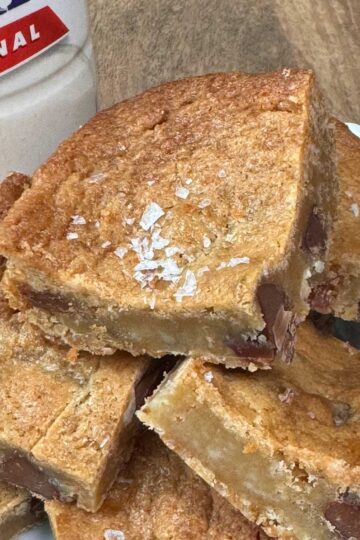 Malted Milk Powder Blondies with sea salt sprinkled on top and milk chocolate chips.