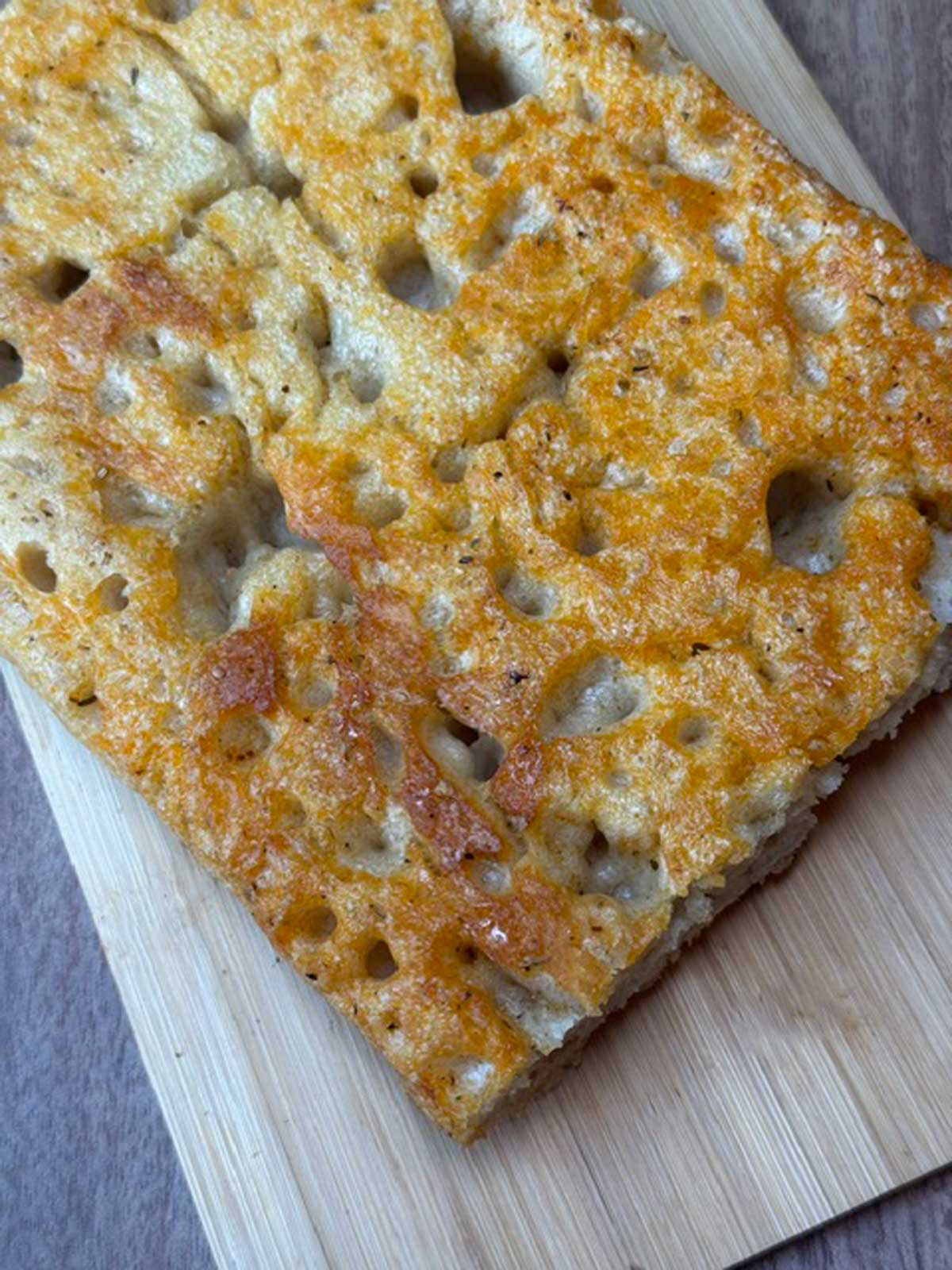 Underside of sourdough focaccia baked in a mini sheet pan or ⅛ sheet pan.